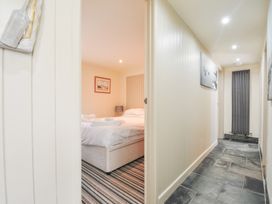 A hallway leading to a bedroom with a bed at Beachside in Polzeath