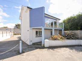 A house with a balcony and driveway at Beachside in Polzeath