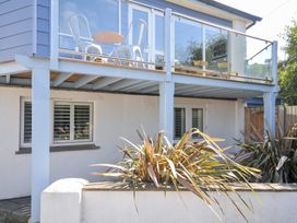 An outdoor balcony with furniture at Beachside in Polzeath