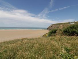 A beach with grass and cliffs at Penpoll Little Petherick Creek near Padstow