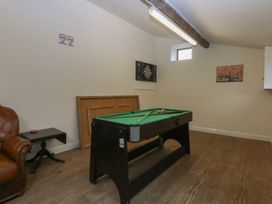 A games room with a pool table and dartboard at Llofft Yr Yd in Porthmadog