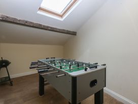 A game room with a foosball table in Llofft Yr Yd Porthmadog