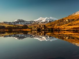 A scenic view of mountains and their reflection in a lake