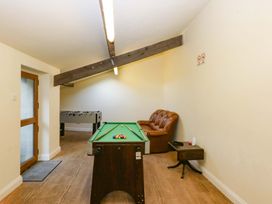 A game room with a pool table and a foosball table at Llofft Yr Yd in Porthmadog