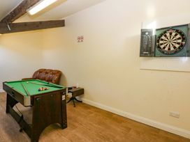 A game room with a pool table and a dartboard at Llofft Yr Yd Porthmadog