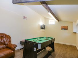 A game room with a pool table and dartboard at Llofft Yr Yd, Porthmadog