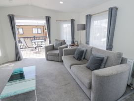 A living room with sofas and a coffee table at Serendipity