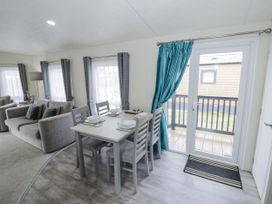 A living room with a dining area and sofa at Serendipity