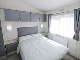 A bedroom with a bed and bedside table at Serendipity