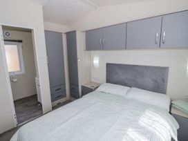 A bedroom with a bed and storage units at Serendipity