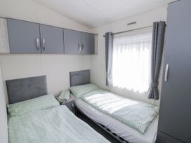 A bedroom with two beds and a window at Serendipity