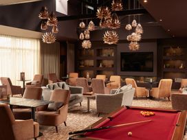 A lounge area with a pool table and seating at Cosy Corner in the Lakes, Greystoke