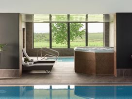 A spa area with a hot tub and reclining chair at Cosy Corner in the Lakes Greystoke