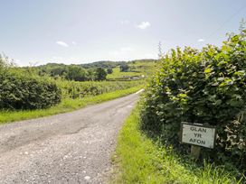 A road with a sign at Glan Yr Afon in Llangernyw
