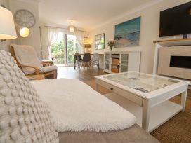 A living room with a coffee table and dining area at Trelowen St Issey near Padstow