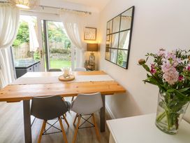 A dining room with a table and chairs at Trelowen in St Issey near Padstow