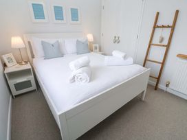 A bedroom with a bed and bedside table at Trelowen in St Issey near Padstow