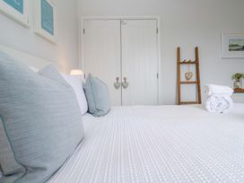 A bedroom with a bed and decorative items at Trelowen St Issey near Padstow