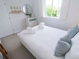 A bedroom with a bed and towels on it at Trelowen in St Issey near Padstow