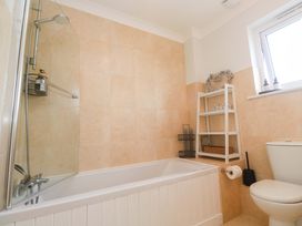 A bathroom with a bathtub and toilet at Trelowen St Issey near Padstow