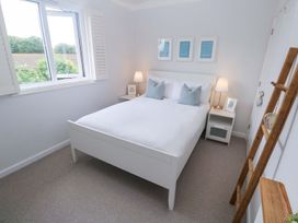 A bedroom with a bed and nightstand at Trelowen St Issey near Padstow