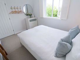 A bedroom with a bed and dresser at Trelowen St Issey near Padstow