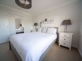 A bedroom with a bed and bedside table at Trelowen St Issey near Padstow