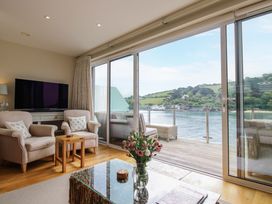 A living room with a television and sofa at Villa 1, Estura Salcombe