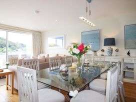 A dining room with a table and chairs at Villa 1, Estura, Salcombe