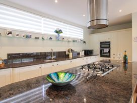 A kitchen with a cooking stove and sink at Villa 1, Estura Salcombe
