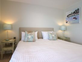 A bedroom with a bed and bedside tables at Villa 1, Estura Salcombe