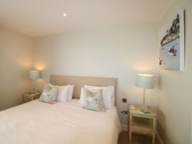 A bedroom with a bed and bedside table at Villa 1, Estura in Salcombe