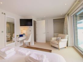 A bedroom with bed and desk in Villa 1, Estura Salcombe
