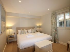 A bedroom with a bed and lamps at Villa 1, Estura in Salcombe