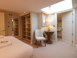 A bedroom with a bed and a mirror at Villa 1, Estura Salcombe