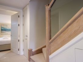 A staircase leading to upstairs rooms at Villa 1, Estura in Salcombe