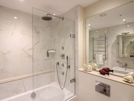 A bathroom with a shower and bathtub at Villa 1, Estura in Salcombe