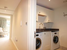 A laundry room with washing machine and dryer at Villa 1, Estura, Salcombe