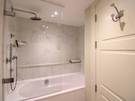 A bathroom with a shower and bathtub at Villa 1, Estura in Salcombe