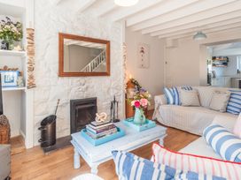 A living room with a coffee table and fireplace at Gerallt in Morfa Nefyn