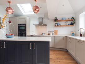 A kitchen with cabinets and countertop at Gerallt in Morfa Nefyn