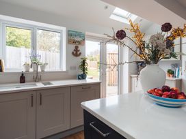A kitchen with cabinets and a sink at Gerallt in Morfa Nefyn