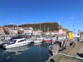 A marina with boats and buildings at Lonsdale Villa in Scarborough