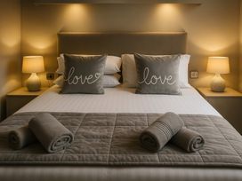 A bedroom with a bed and pillows at Birch Lodge Warton near Carnforth