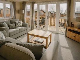 A living room with sofas and a coffee table at Birch Lodge in Warton near Carnforth
