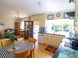 A kitchen with a table and chairs at Waterfall House in Dunmanway, County Cork