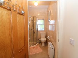 A bathroom with a shower, toilet, and sink at Waterfall House, Dunmanway, County Cork