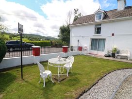 A garden with a table and chairs at Waterfall House, Dunmanway, County Cork