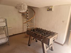 A game room with a foosball table and a bunk bed at Pennant Tigi Uchaf in Dinas Mawddwy