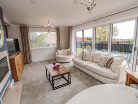 A living room with a sofa and television at Wyvill House in Cayton